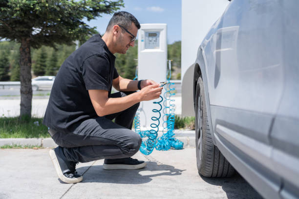 Man Checking Air Pressure In The Car Tire