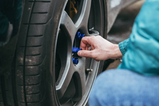 Man tighten blue lug nuts