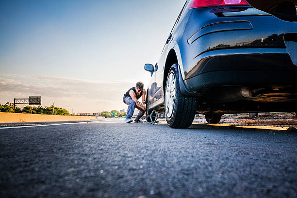 changing the flatten tire at the highway