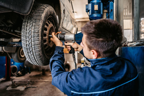 flat tire on car in a repair shop.