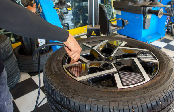 changing tire of car in garage.