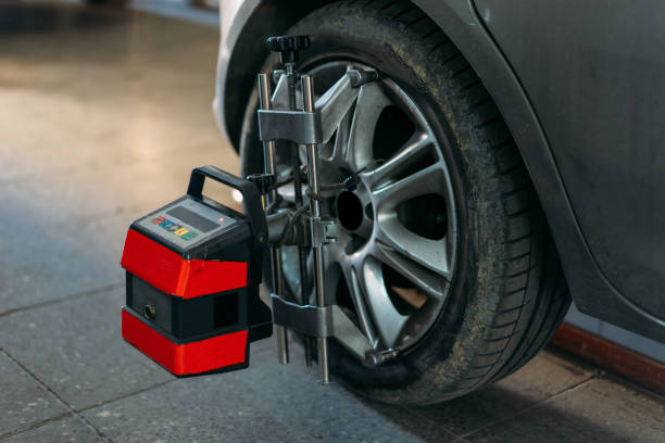 Closeup of tire clamped with aligner undergoing auto wheel align