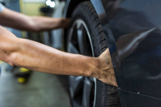 setting brand new tire on car