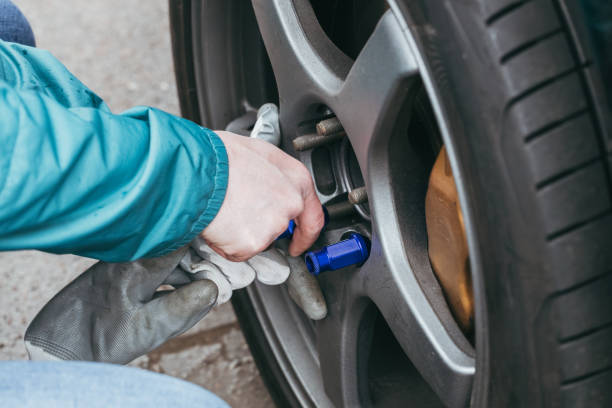  tighten blue lug nuts on tire